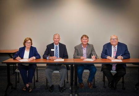 Dr. Cynthia Bambara, Dr. Richard Midcap, Dr. Chris Gilmer and Dr. Tom Striplin seated at a table.